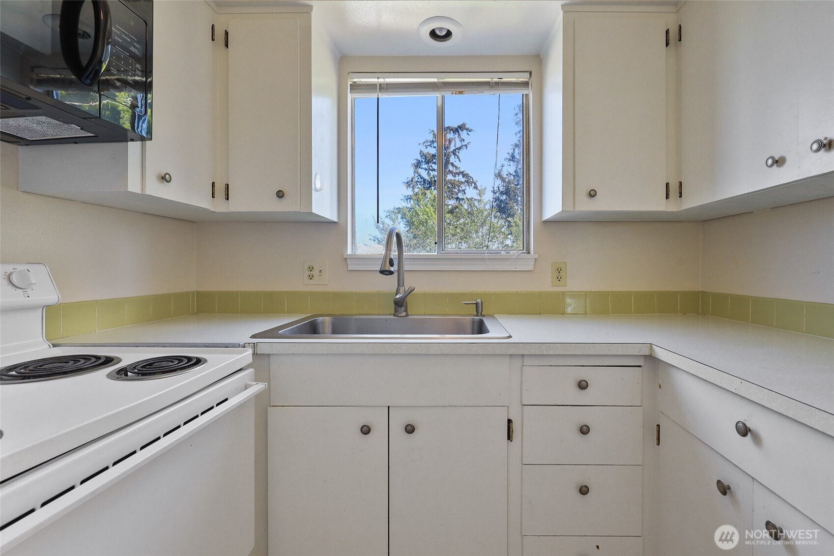 1719 North Willow Road Spokane Valley, WA 99206 - Photo 12 of 27 a kitchen with cabinets appliances and a window