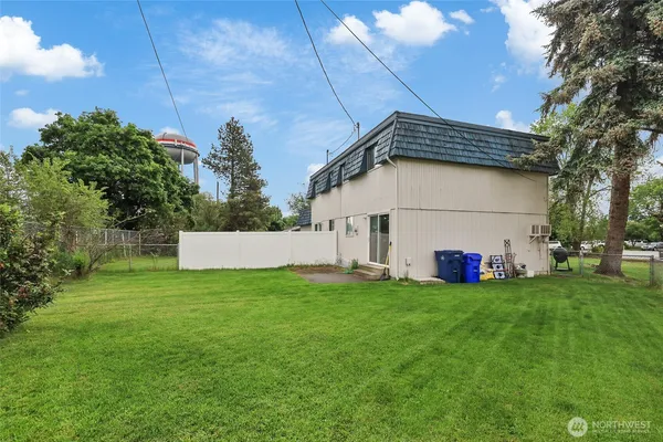 a backyard of a house with table and chairs