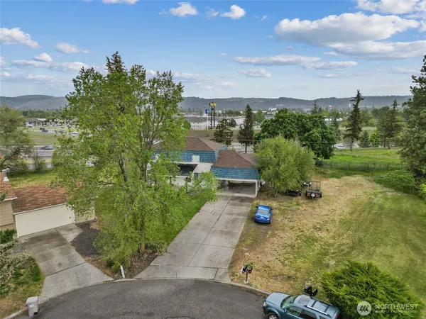 an aerial view of a house with a yard