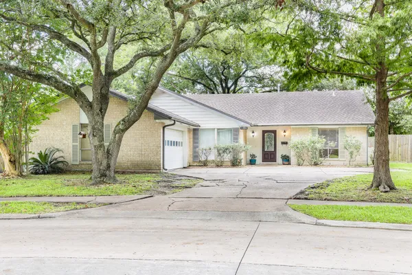 a house that has a tree in front of it
