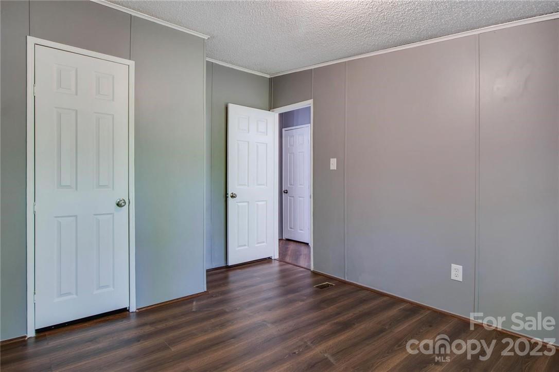 65 Hickory Nut Drive Mill Spring, NC 28756 - Photo 12 of 24 a view of an empty room with wooden floor