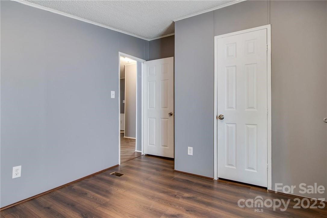 65 Hickory Nut Drive Mill Spring, NC 28756 - Photo 14 of 24 a view of an empty room with wooden floor
