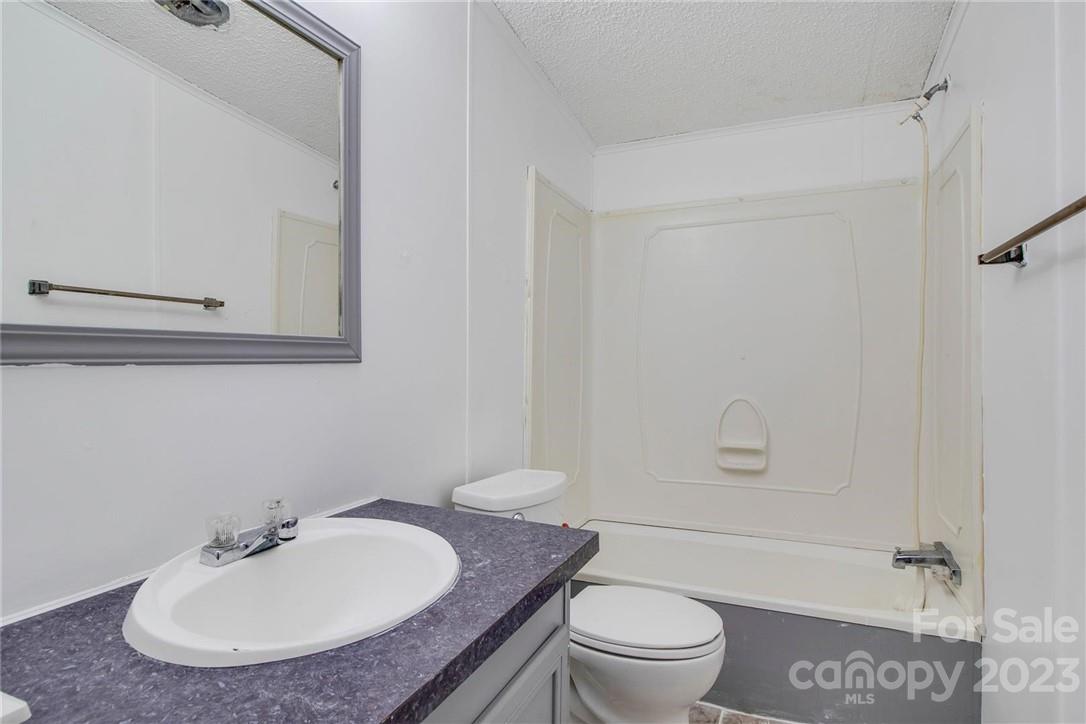 65 Hickory Nut Drive Mill Spring, NC 28756 - Photo 19 of 24 a bathroom with a sink toilet and shower