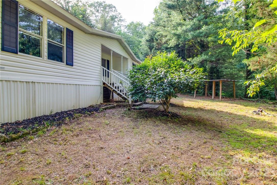 65 Hickory Nut Drive Mill Spring, NC 28756 - Photo 2 of 24 a backyard of a house with lots of green space