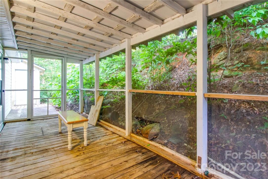65 Hickory Nut Drive Mill Spring, NC 28756 - Photo 21 of 24 a view of a room with wooden floor and outdoor space