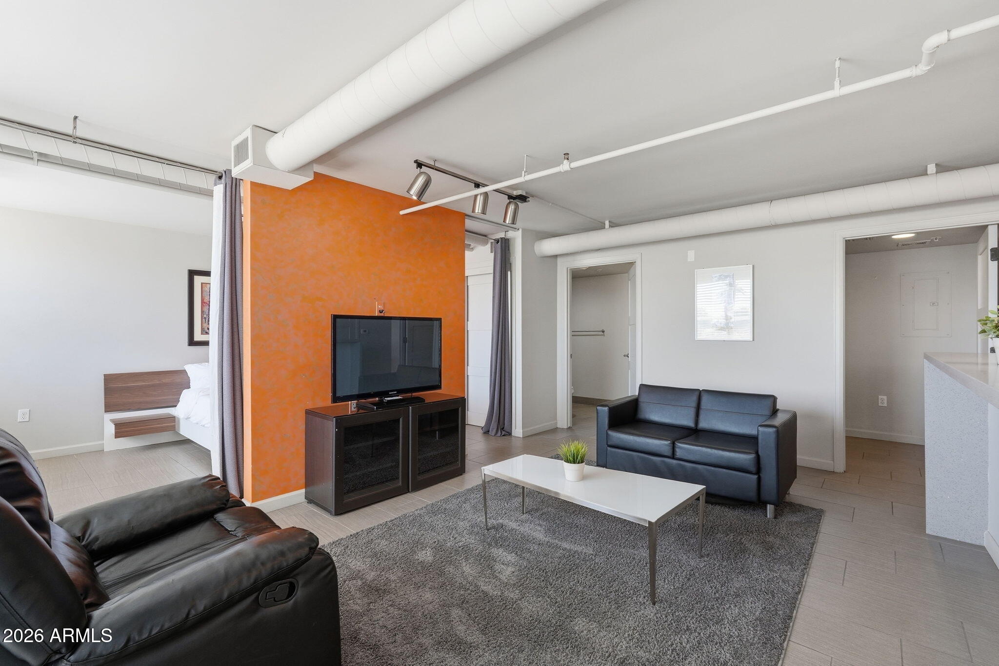 535 West Thomas Road, Unit 210 Phoenix, AZ 85013 - Photo 4 of 40 a living room with furniture and a flat screen tv