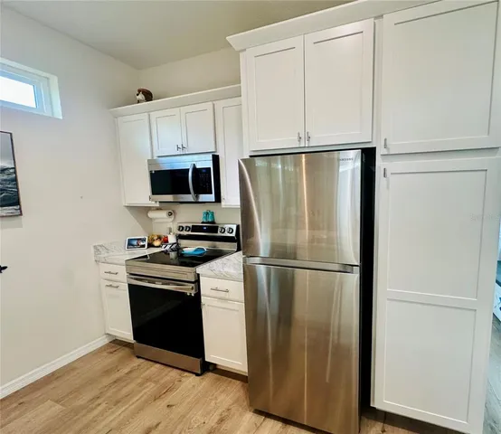 a kitchen with wooden cabinets and stainless steel appliances