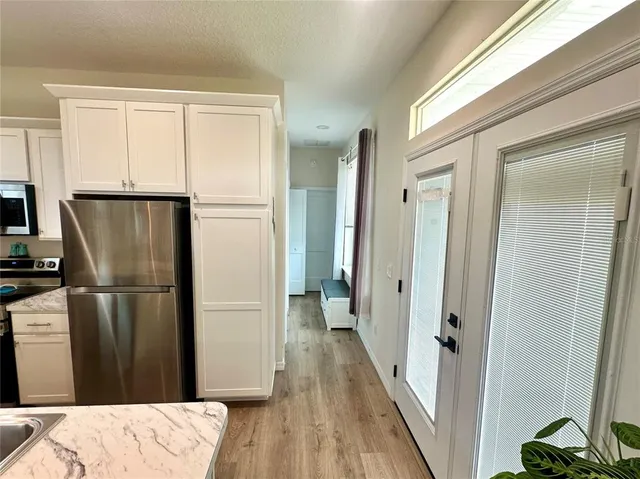 a refrigerator freezer sitting inside of a kitchen