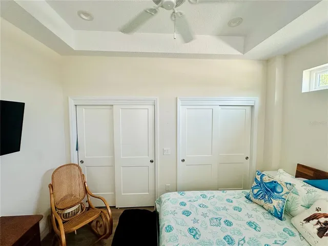 a bedroom with a bed a couch and chair