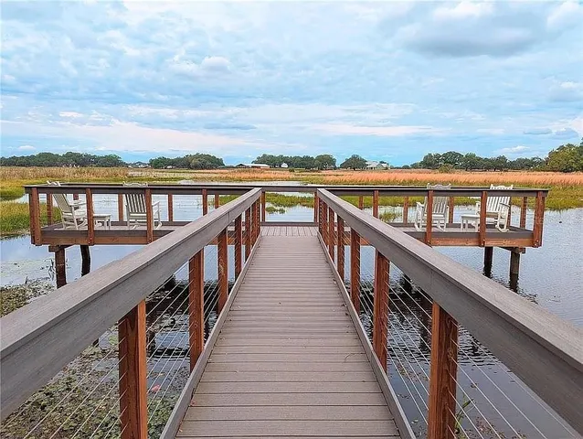 a view of balcony with wooden floor and fence