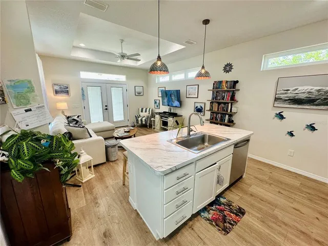 a very nice looking room with kitchen view and wooden floor