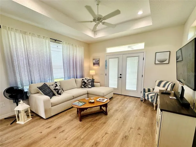 a living room with furniture and wooden floor