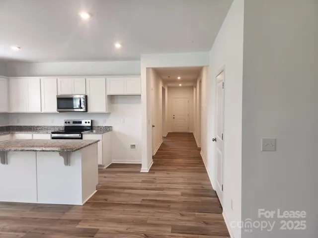 a kitchen with granite countertop a stove and a sink