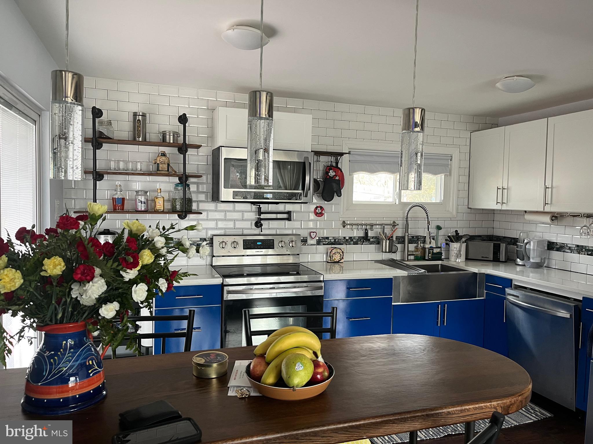 936 Wood Road Feasterville-Trevose, PA 19053 - Photo 4 of 29 a kitchen with stainless steel appliances granite countertop a sink a stove and a wooden floors