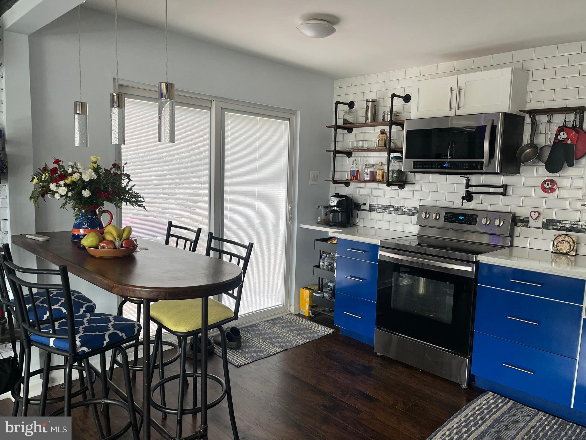 936 Wood Road Feasterville-Trevose, PA 19053 - Photo 5 of 29 a kitchen with stainless steel appliances a stove a microwave a sink and a refrigerator