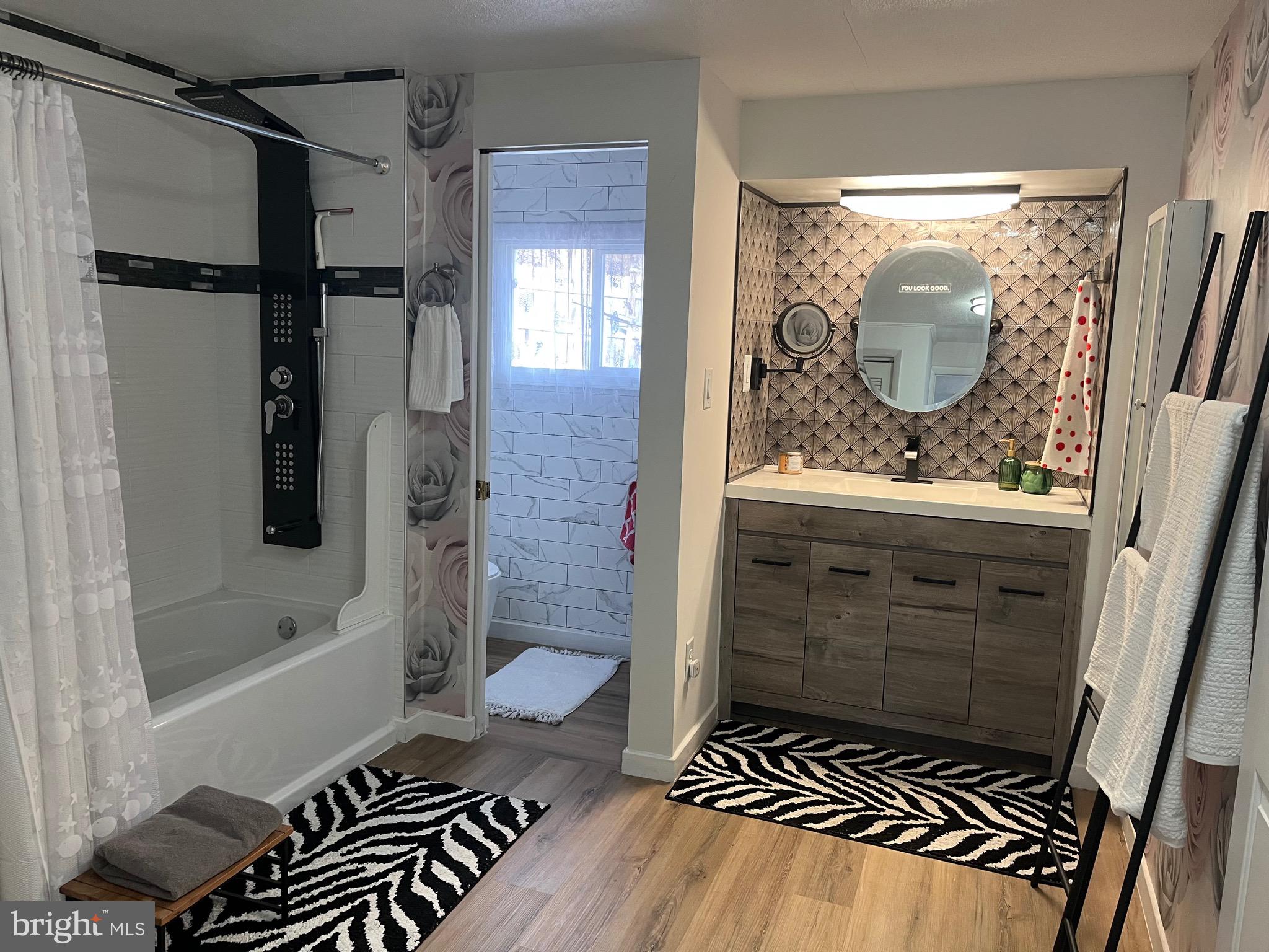 936 Wood Road Feasterville-Trevose, PA 19053 - Photo 7 of 29 a bathroom with a shower a mirror and a sink