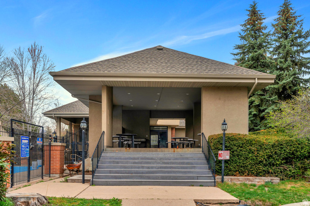 3221 North Shadowbrook Circle Provo, UT 84604 - Photo 25 of 29 Covered outdoor pavilion featuring a gabled roof, stucco exterior, and multi-tiered staircase with black metal railings