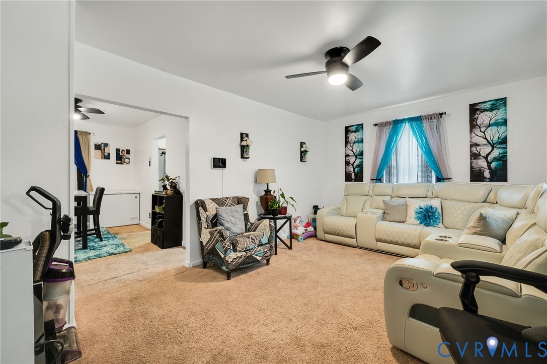 2909 Springview Drive Richmond, VA 23234 - Photo 7 of 19 a living room with furniture gym equipment and a chandelier