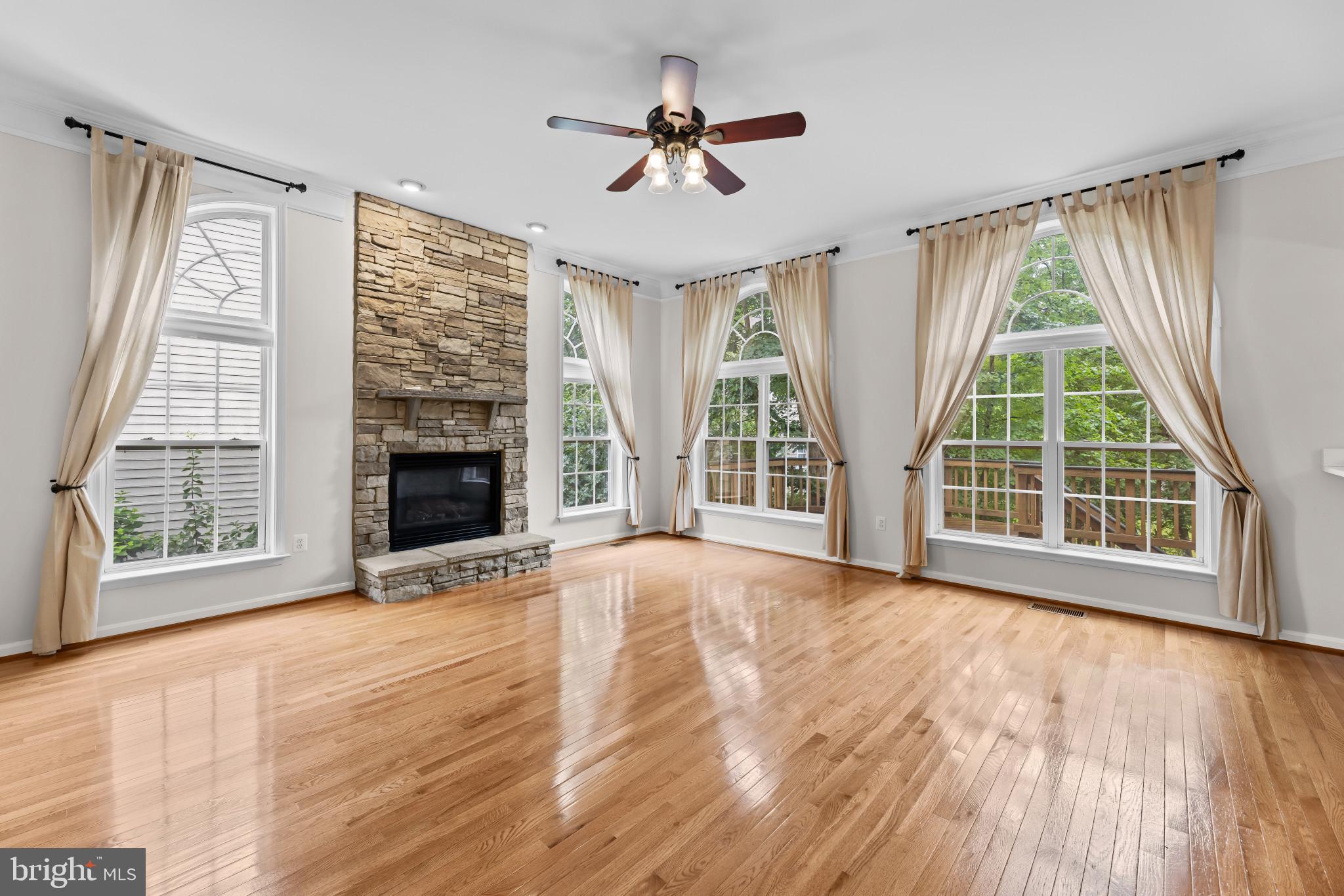 42920 Cattail Meadows Place Broadlands, VA 20148 - Photo 12 of 55 a view of an empty room with wooden floor and a window