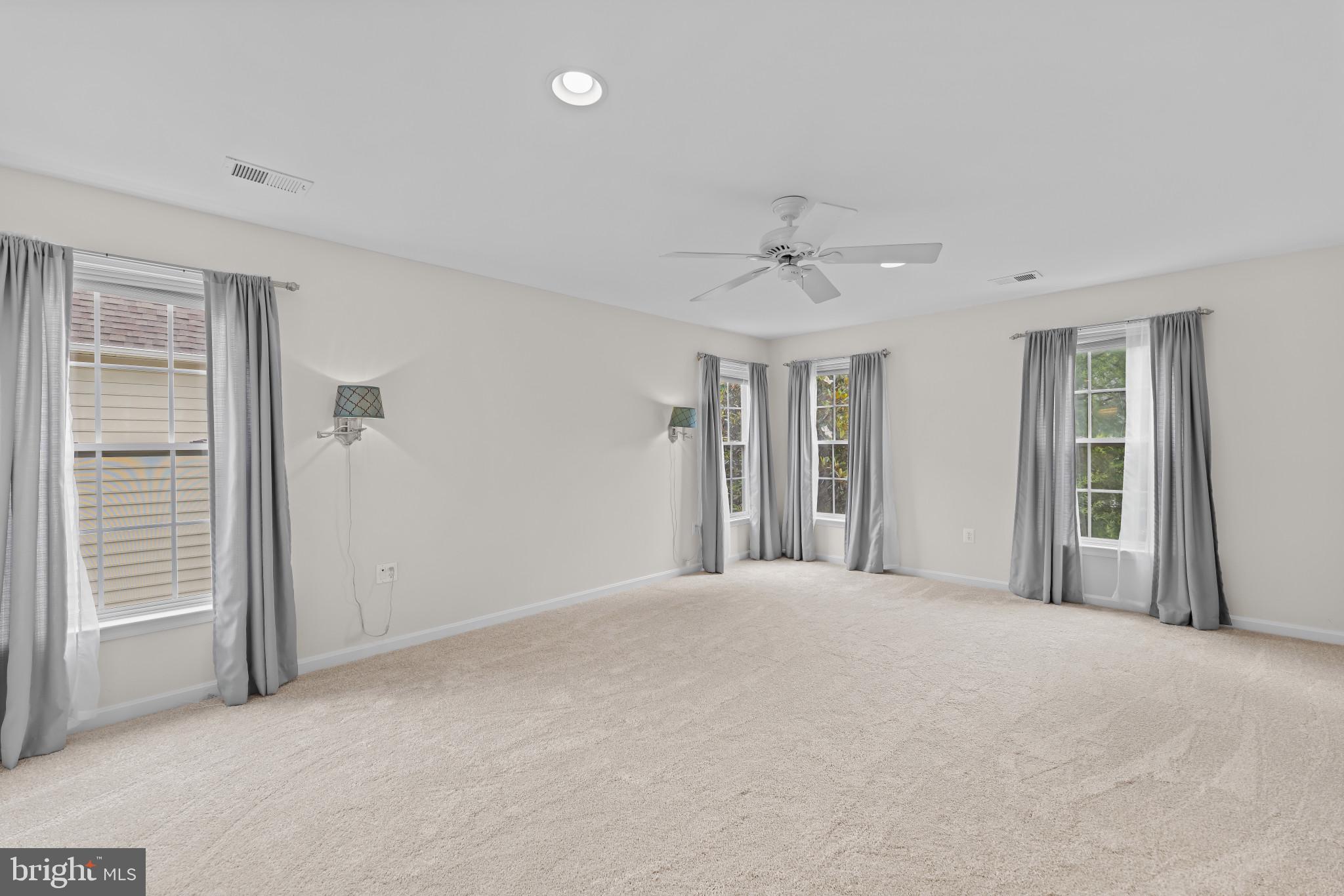 42920 Cattail Meadows Place Broadlands, VA 20148 - Photo 22 of 55 a view of a big room with windows and chandelier fan