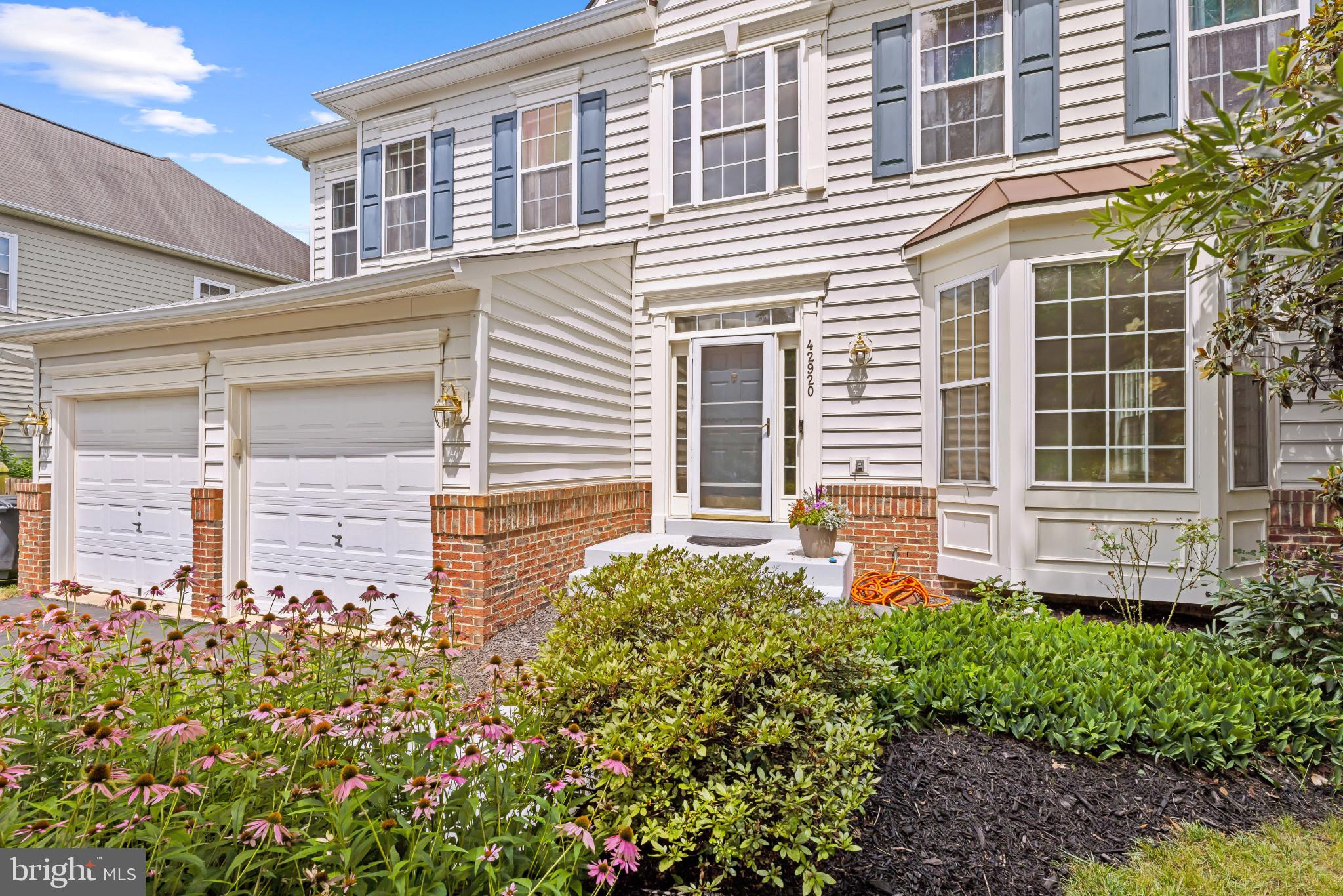 42920 Cattail Meadows Place Broadlands, VA 20148 - Photo 3 of 55 a front view of a house with a garden