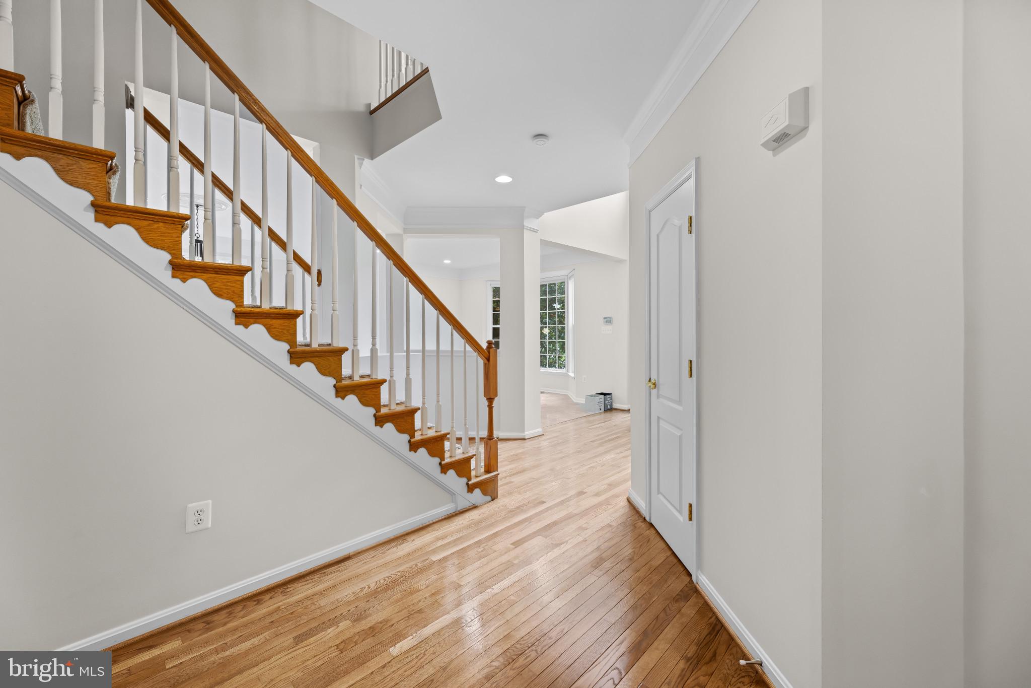 42920 Cattail Meadows Place Broadlands, VA 20148 - Photo 6 of 55 a view of a hallway with wooden floor and staircase