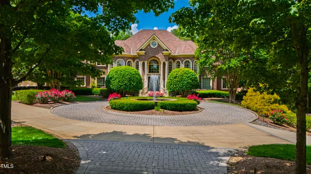 a front view of a house with a yard and potted plants
