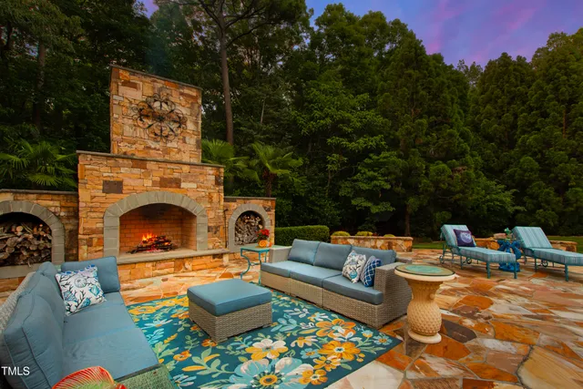 a swimming pool with outdoor seating and yard