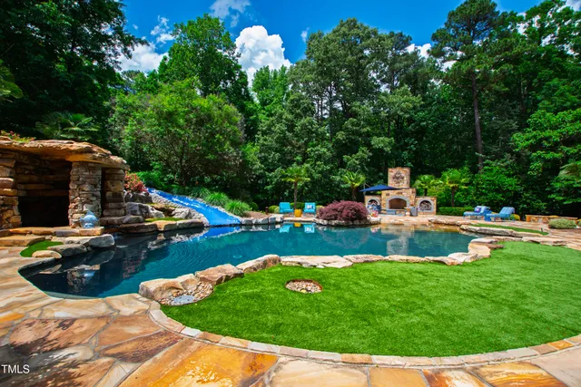 a living room with fireplace furniture and a large window