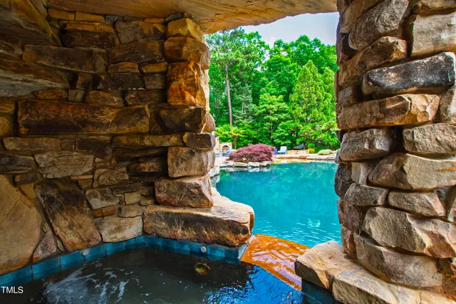 a kitchen with stainless steel appliances granite countertop a sink a stove and a wooden floors