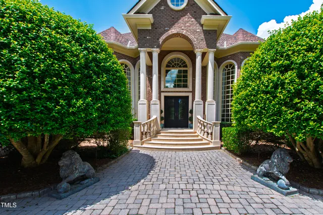 a view of a hallway with wooden floor and front door