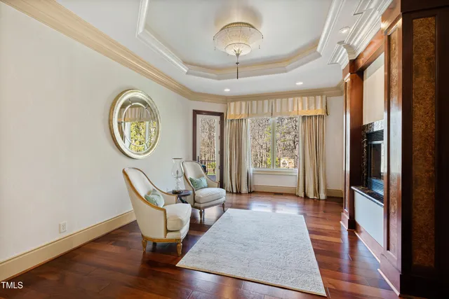 a view of an empty room with a fireplace and window