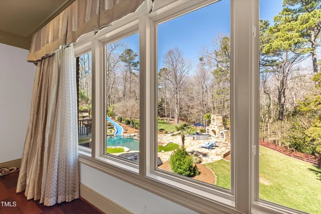 an aerial view of a house with a swimming pool and garden