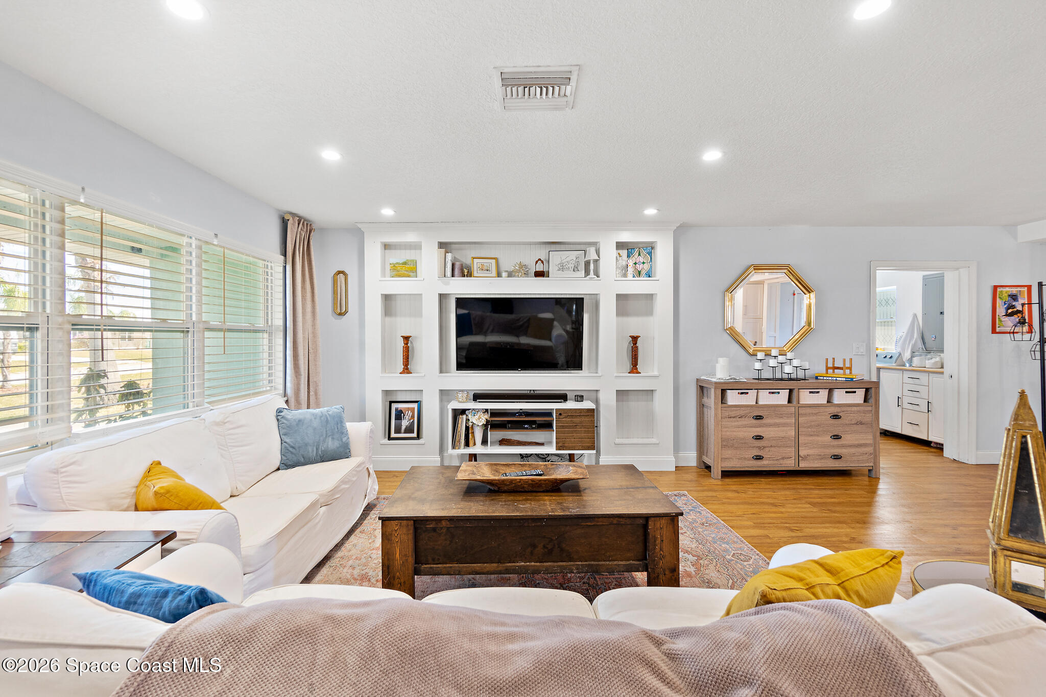 740 Java Road Cocoa Beach, FL 32931 - Photo 24 of 40 a living room with furniture a flat screen tv and a large window