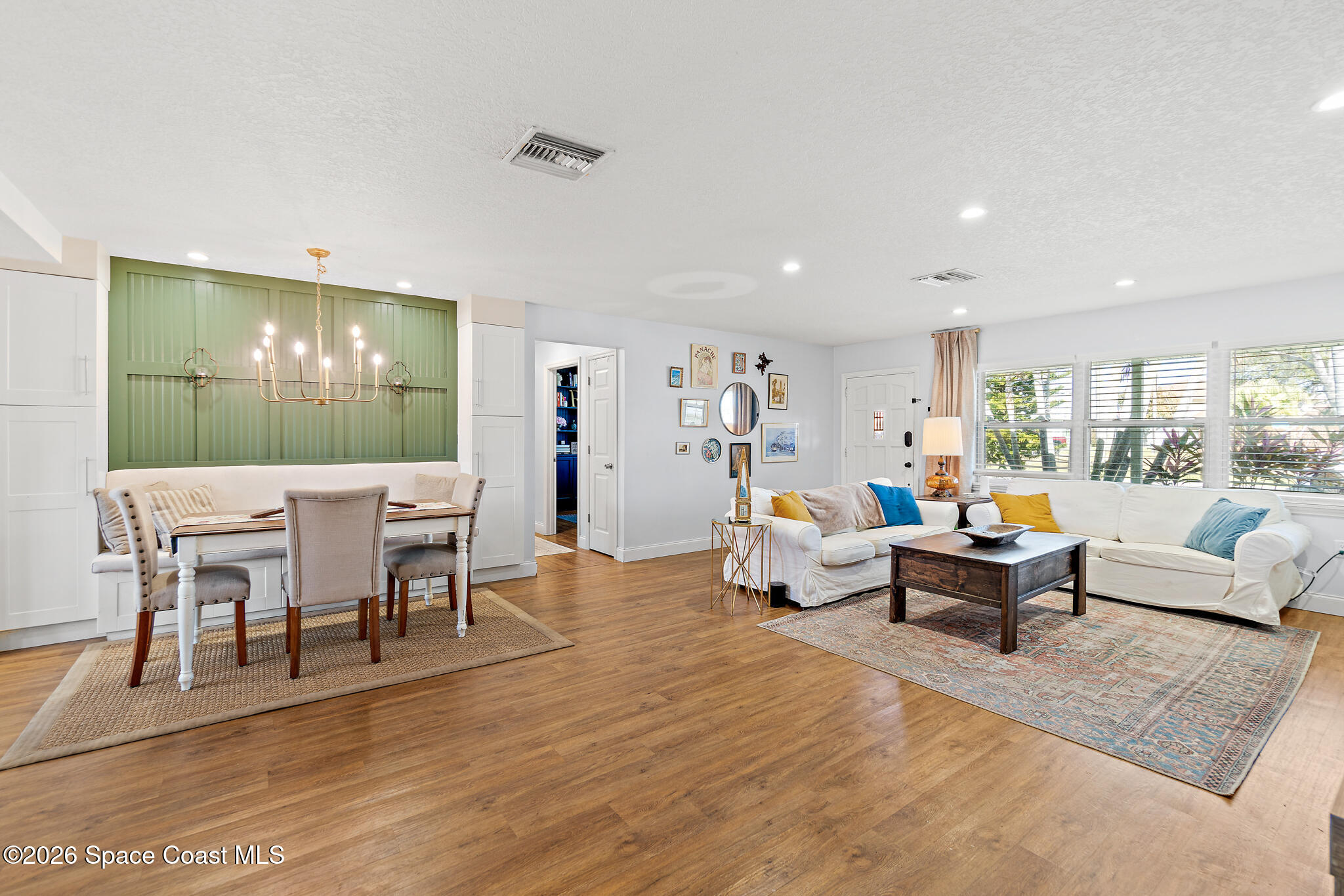 740 Java Road Cocoa Beach, FL 32931 - Photo 40 of 40 a living room with furniture and a large mirror with wooden floor