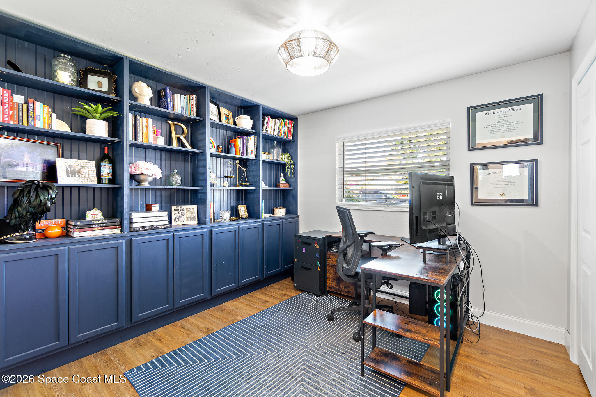 740 Java Road Cocoa Beach, FL 32931 - Photo 8 of 40 a work room with furniture and a bookshelf