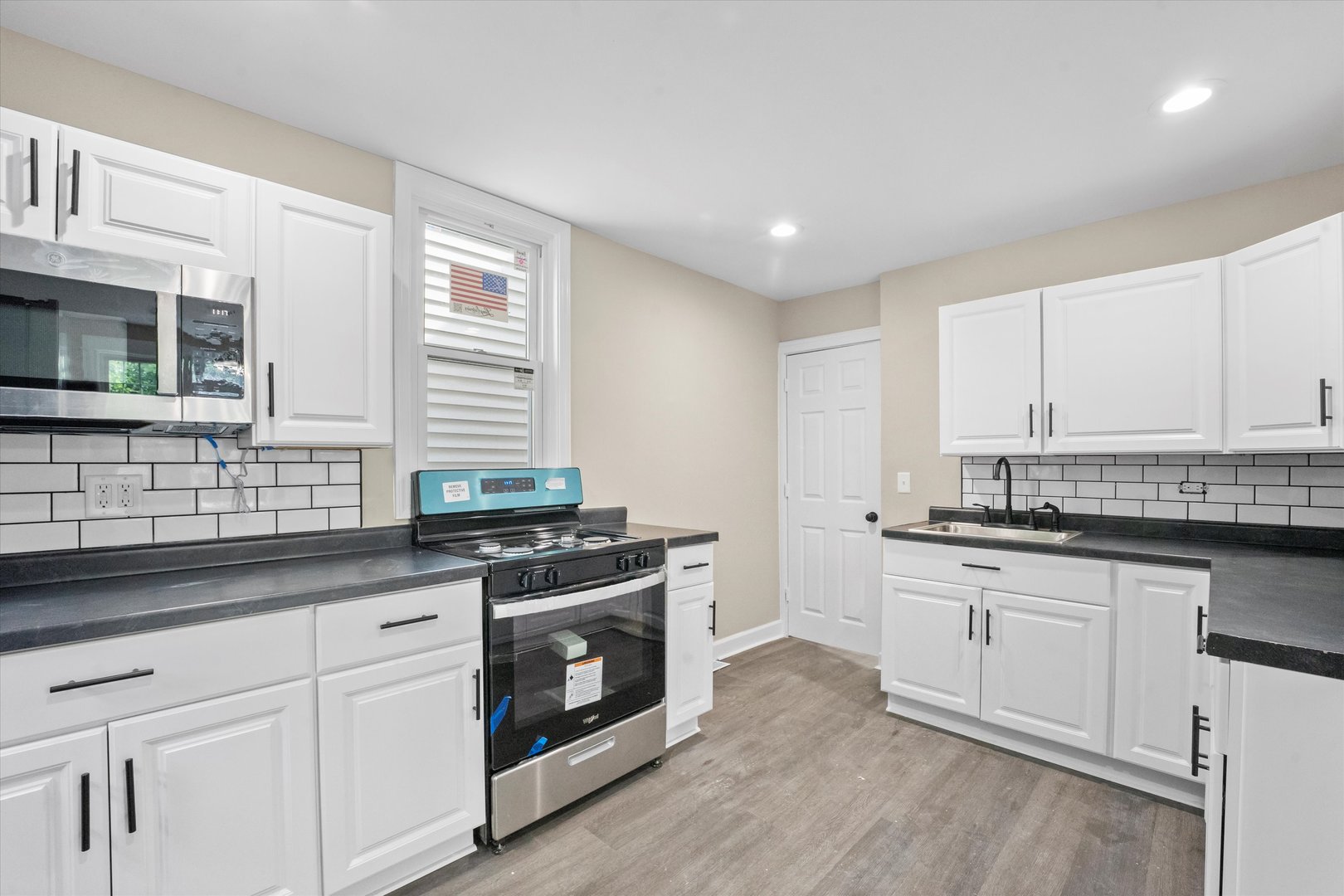 7224 South Union Avenue Chicago, IL 60621 - Photo 14 of 43 a kitchen with granite countertop cabinets stainless steel appliances and a sink
