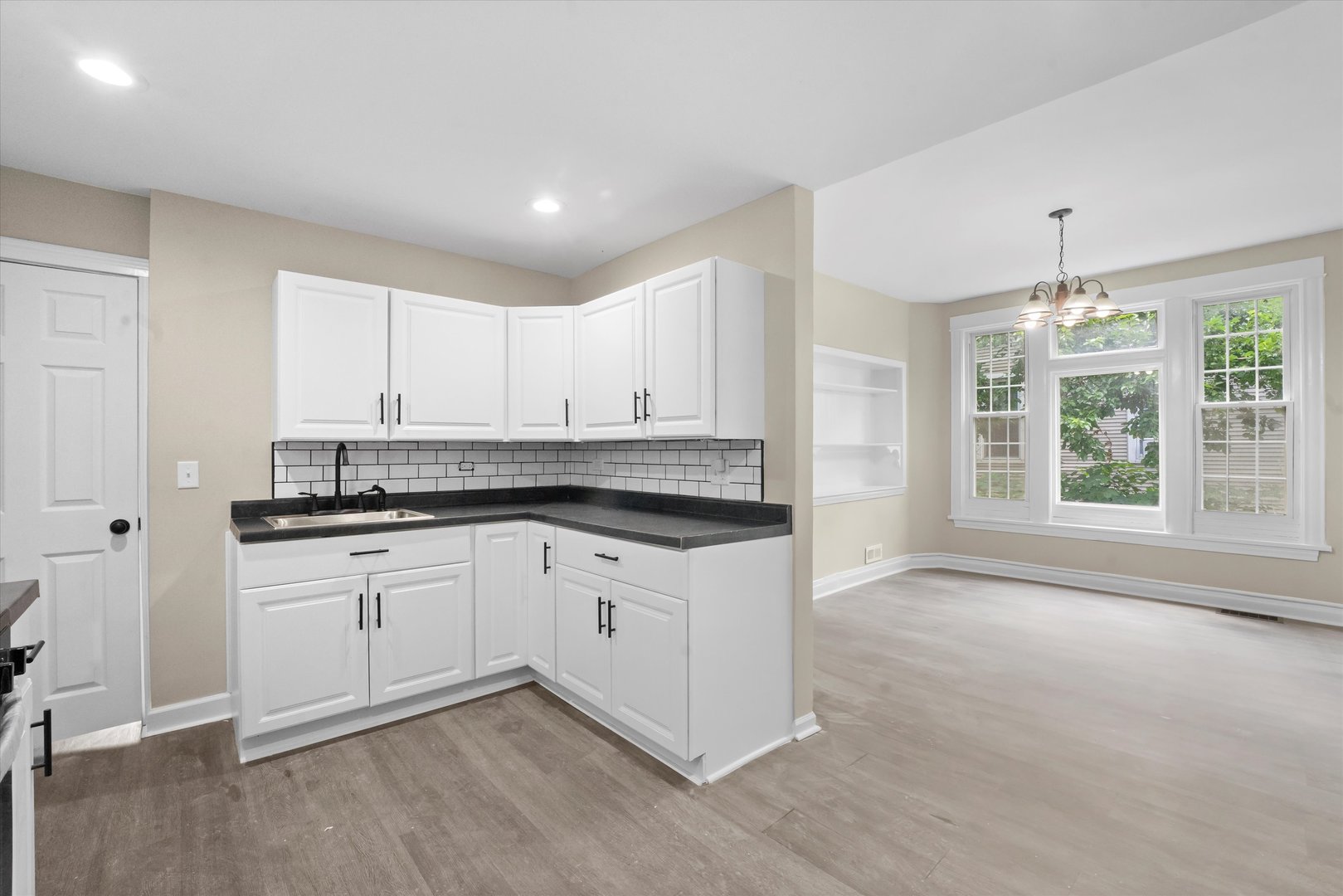 7224 South Union Avenue Chicago, IL 60621 - Photo 16 of 43 a kitchen with granite countertop white cabinets and white appliances