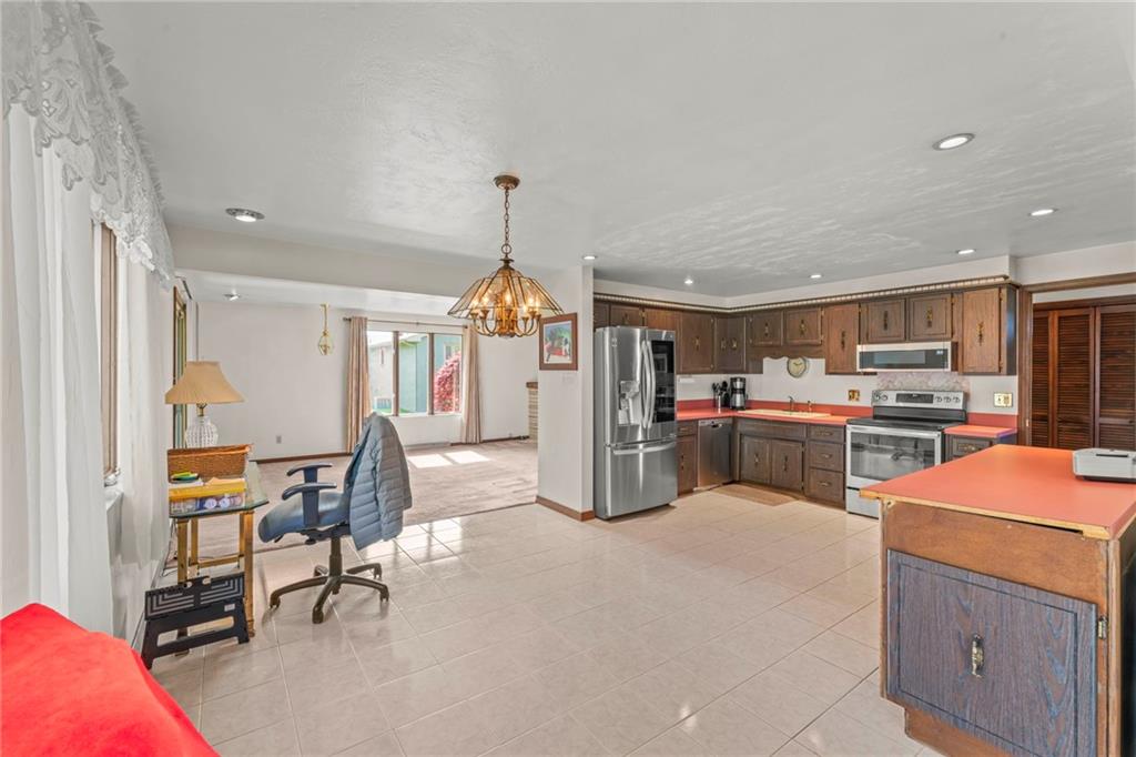 254 Walnut Street Houston, PA 15342 - Photo 12 of 29 a open kitchen with stainless steel appliances kitchen island granite countertop a table chairs and a refrigerator