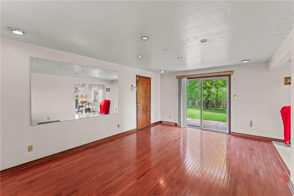 254 Walnut Street Houston, PA 15342 - Photo 15 of 29 a view of an empty room with wooden floor and a window