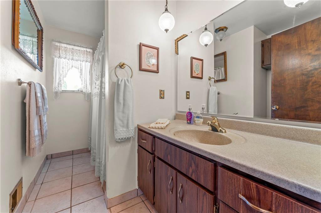 254 Walnut Street Houston, PA 15342 - Photo 18 of 29 a bathroom with a sink vanity granite and a mirror