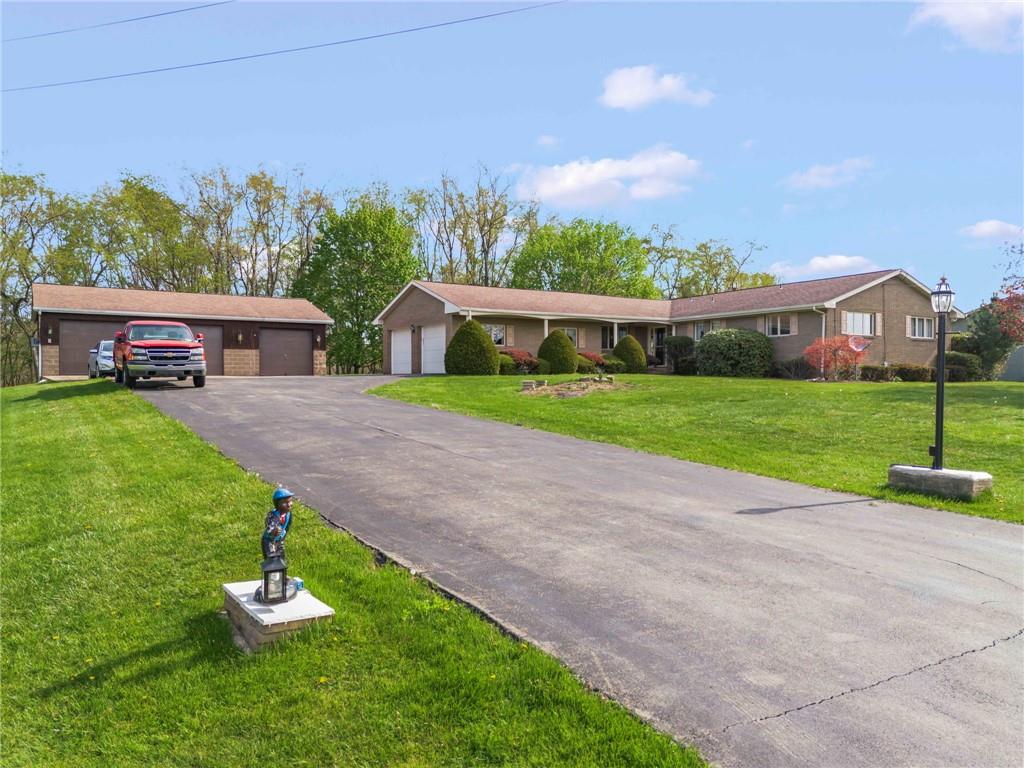 254 Walnut Street Houston, PA 15342 - Photo 2 of 29 a front view of a house with a yard and garage