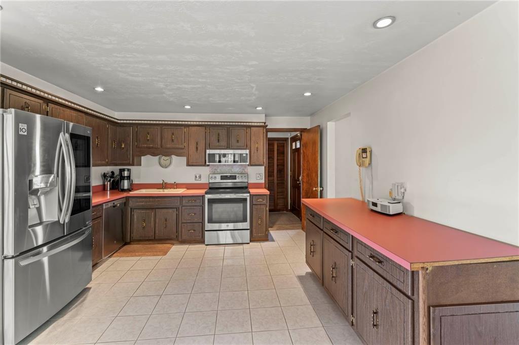 254 Walnut Street Houston, PA 15342 - Photo 10 of 29 a kitchen with stainless steel appliances a sink and a refrigerator