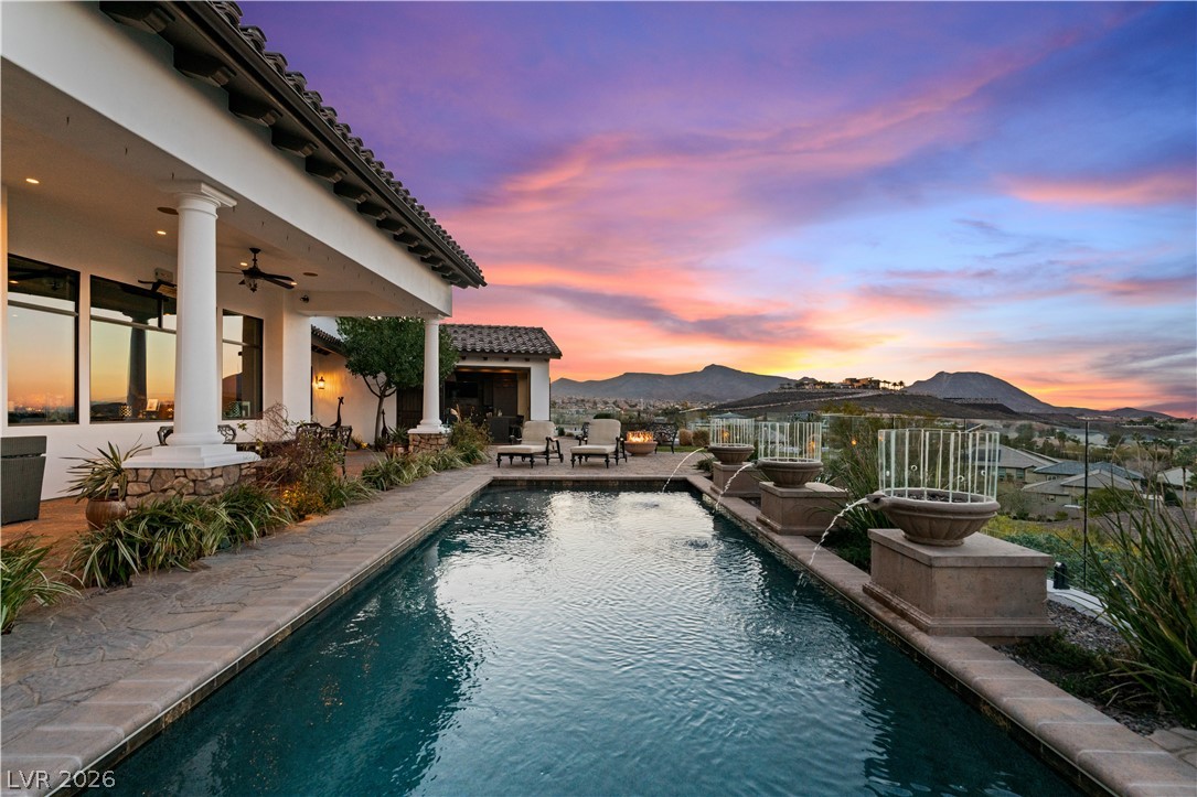 1123 Christian Road Henderson, NV 89002 - Photo 67 of 94 An inviting pool, patio, and outdoor living area with impressive mountain views and sunset hues.