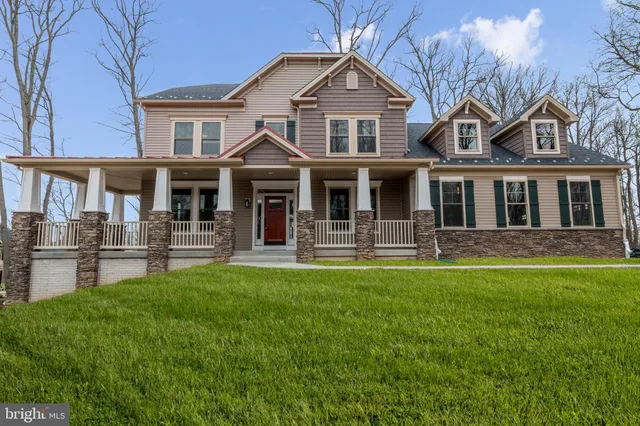 a front view of a house with swimming pool and garden