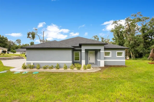 a view of a house with swimming pool and a yard
