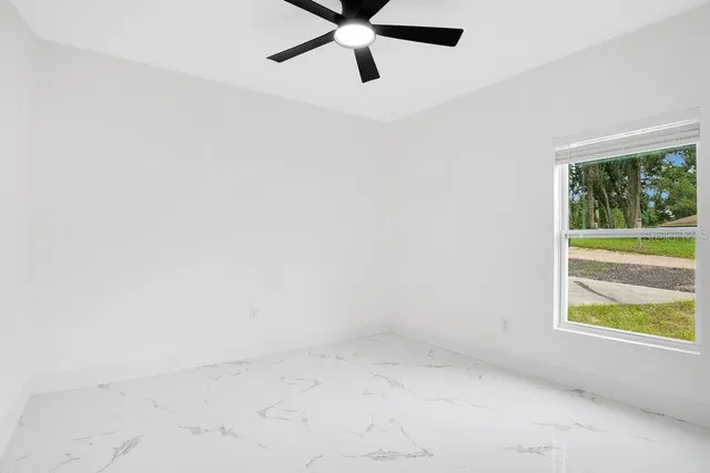 a bedroom with a bed and a potted plant