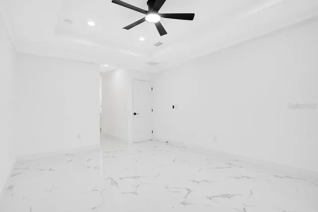 a large white kitchen with a large window