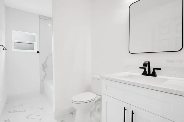 a bathroom with double sink and a mirror