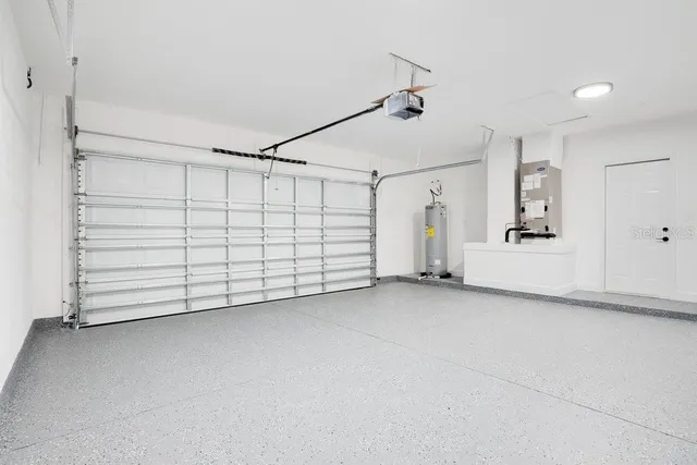 a aerial view of a house with a yard table and chairs